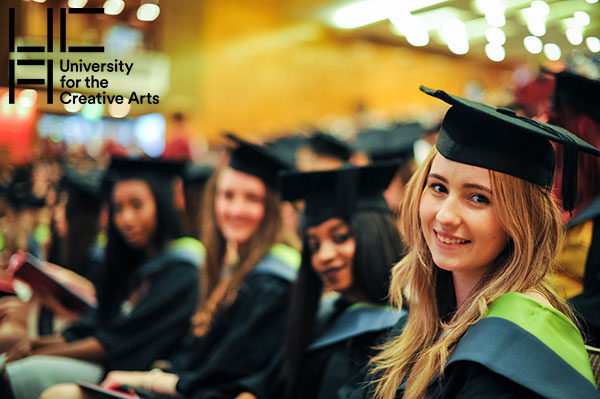 Image used for graduation email headers, shows a row of students seated in the auditorium